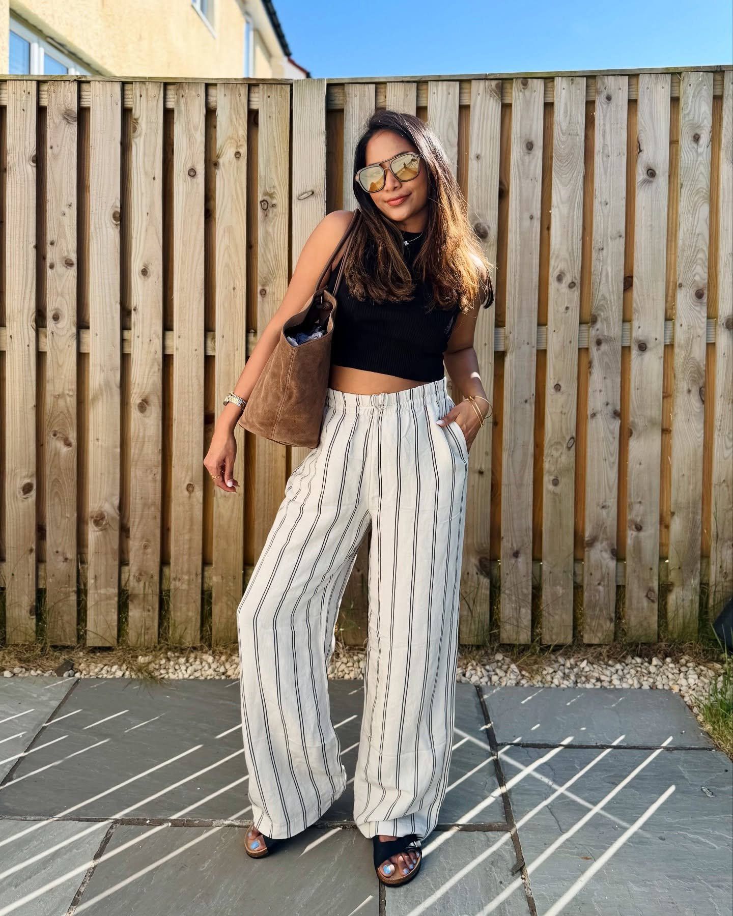 White Striped Linen Trousers with Black Ribbed Crop Top and Suede Tote