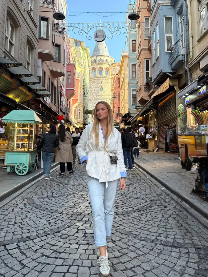 White Tie Waist Blazer with Pale Denim on a Colorful Street