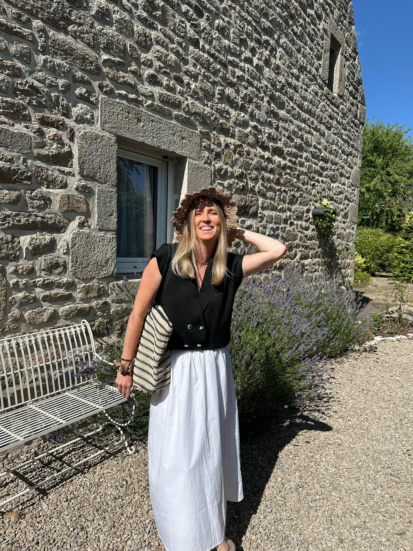 Black Double-Breasted Vest with Flowing White Skirt and Frayed Straw Hat