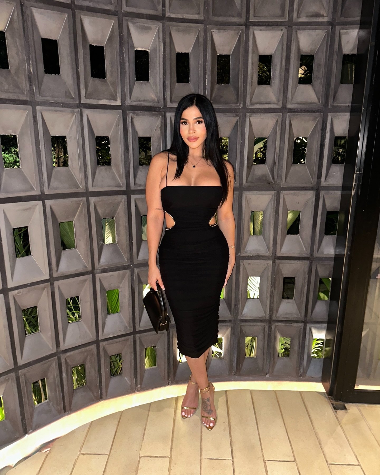 Black Midi Dress with Metallic Waist Cutouts and Gold Sandals