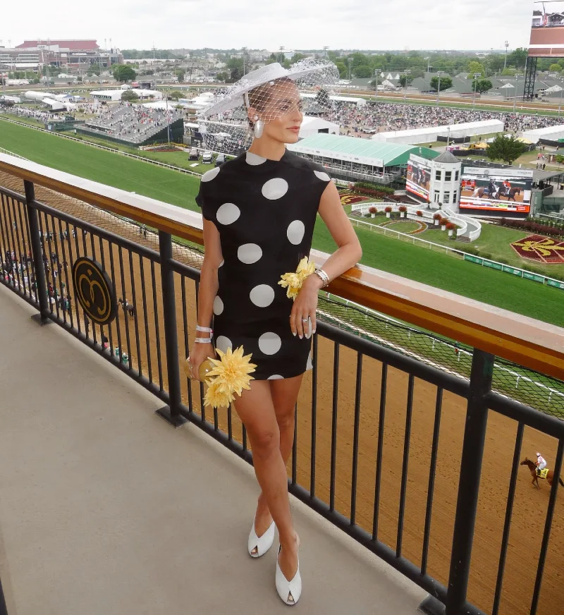 Black Polka Dot Mini Dress with White Veiled Hat and Yellow Floral Accents