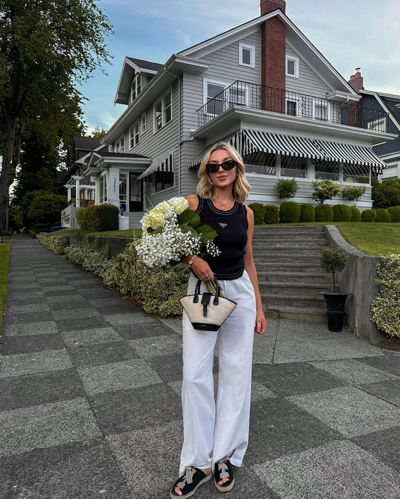Black Ribbed Knit Tank with Flowing White Linen Pants and Canvas Structural Bag