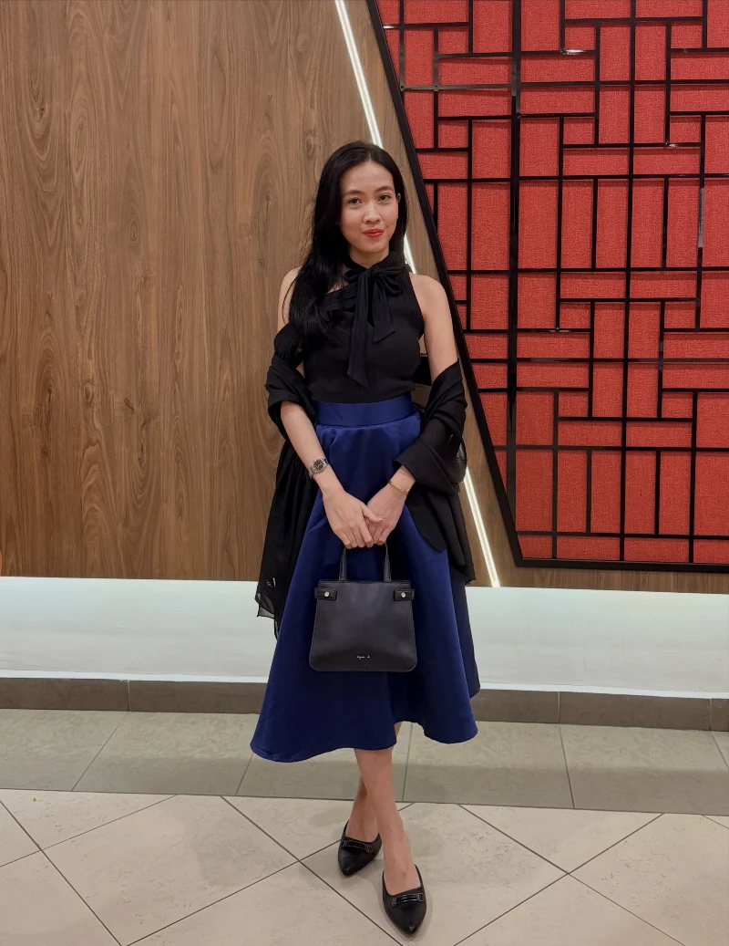 Black Sleeveless Bow Blouse with Royal Blue Satin Midi Skirt and Pointed Flats