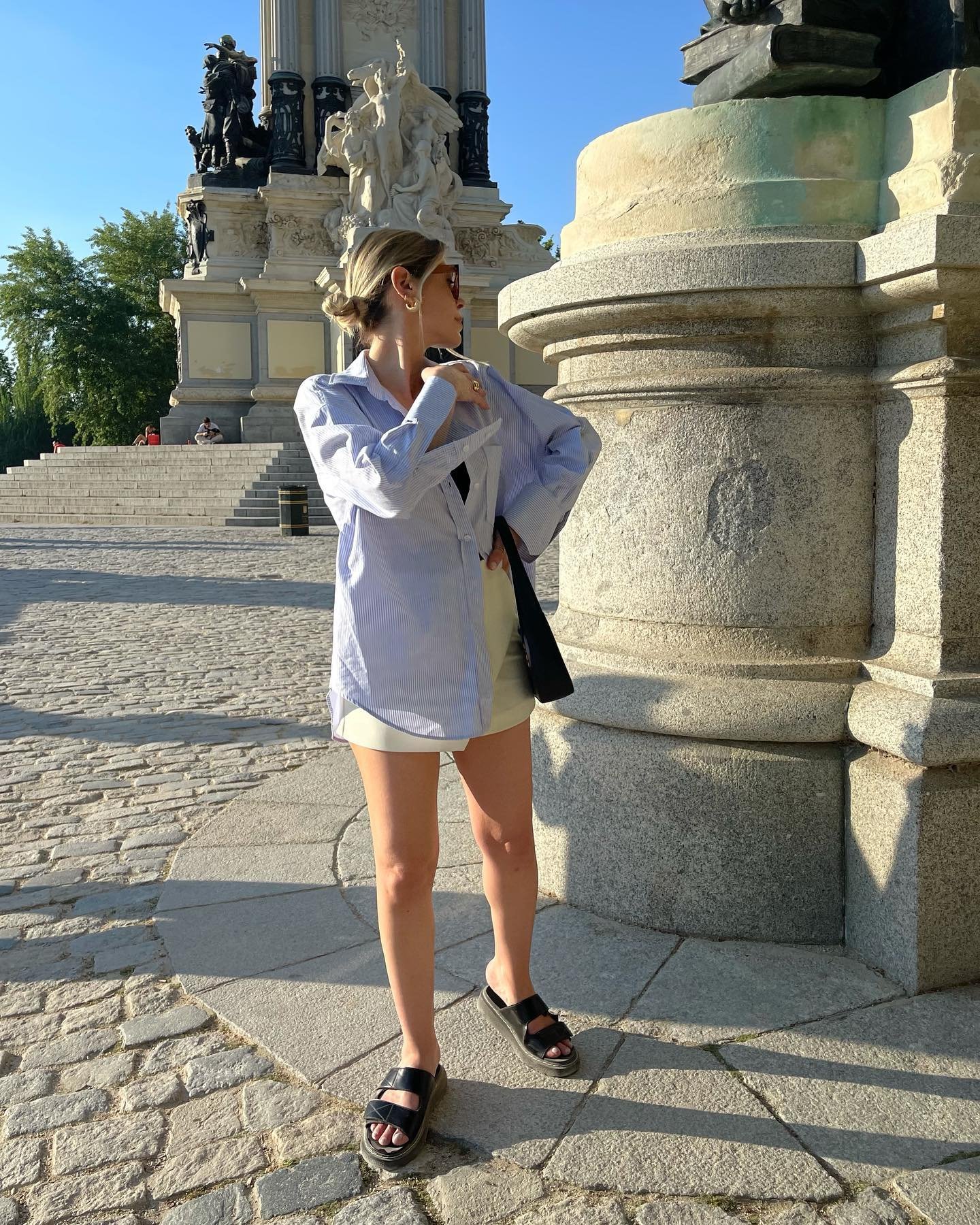 Blue Striped Button-Down Shirt with White Skirt and Chunky Black Leather Sandals Display