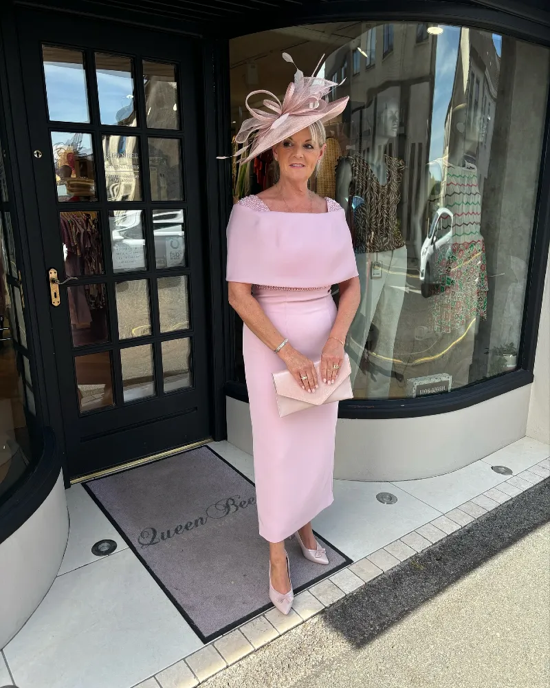 Blush Midi Dress with Architectural Cape Overlay and Matching Fascinator