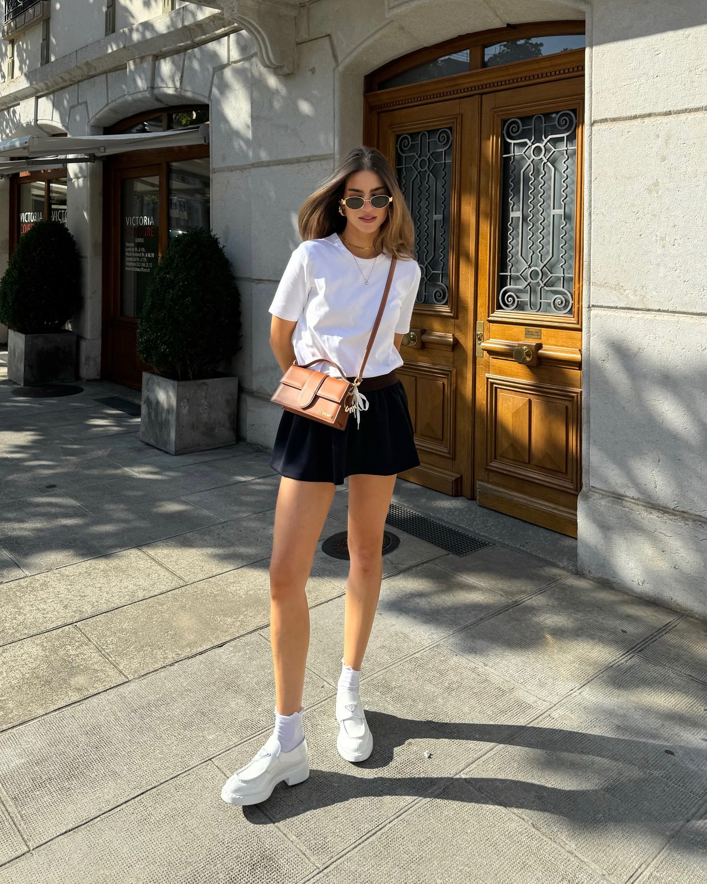 Classic White Crewneck Tee with Pleated Black Mini Skirt and White Platform Loafers Display