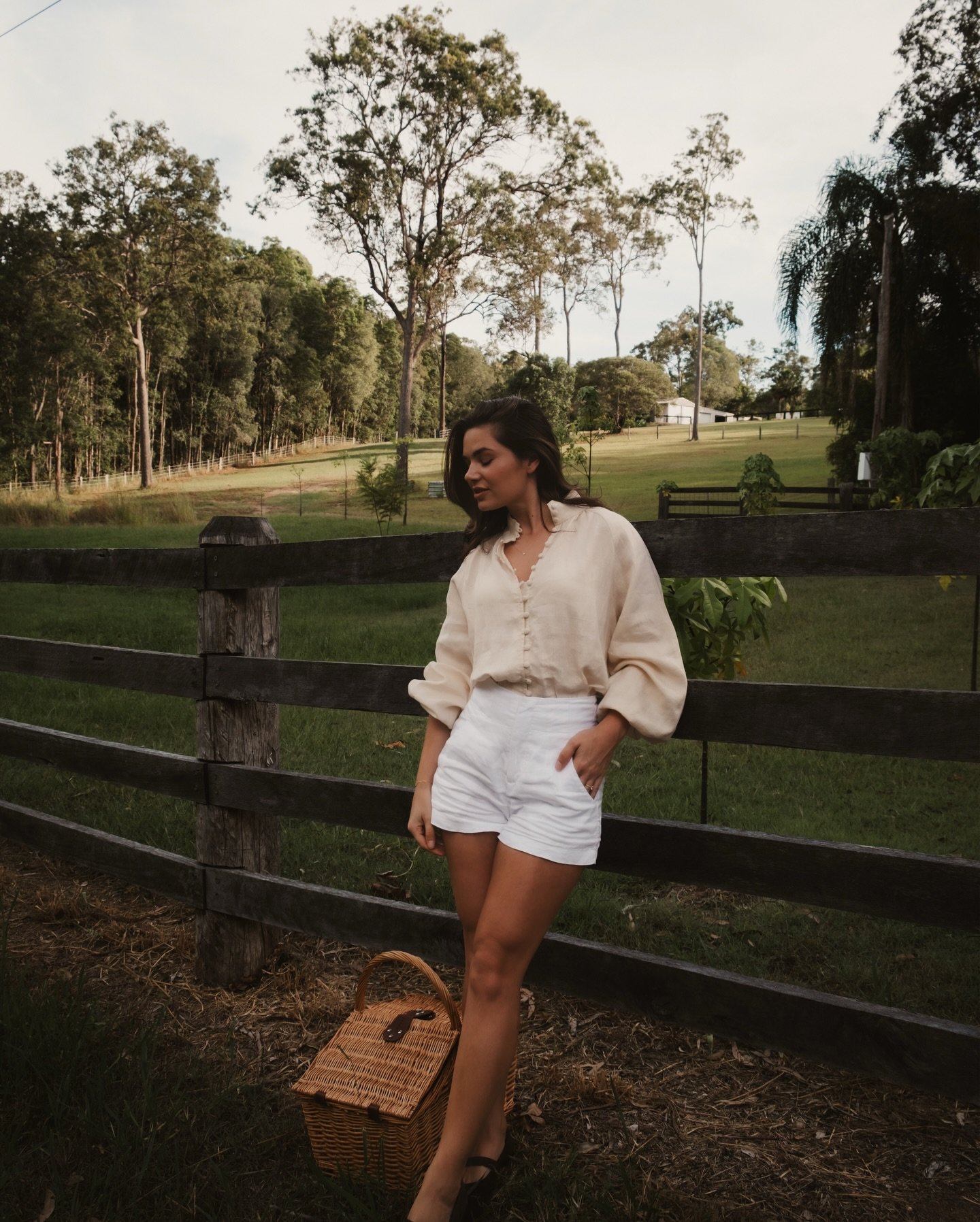 Cream Linen Blouse with White High-Waisted Shorts and Woven Basket