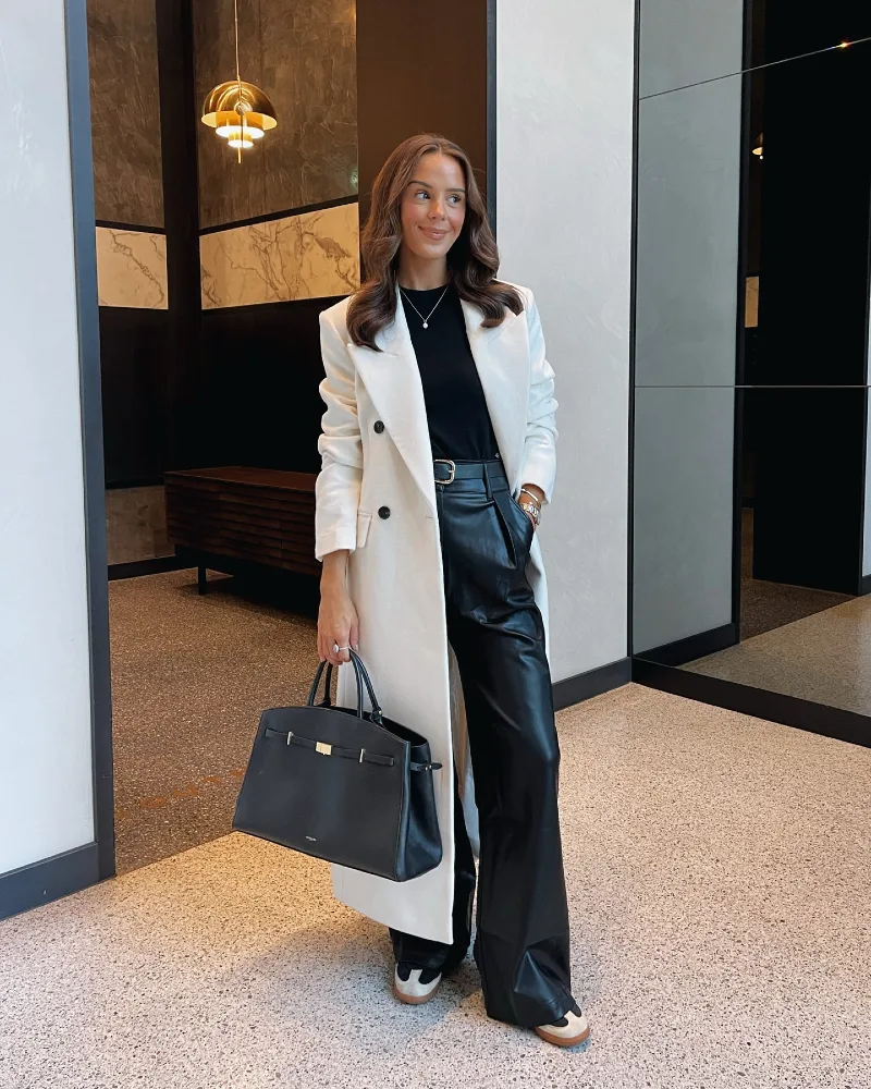 Cream Longline Coat over Black Faux-Leather Trousers