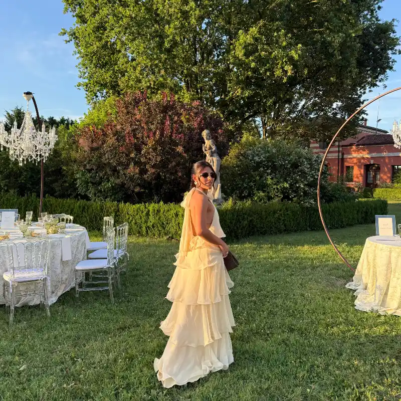 Cream Tiered Ruffle Halter Maxi Dress with Sunglasses and Outdoor Reception Setup