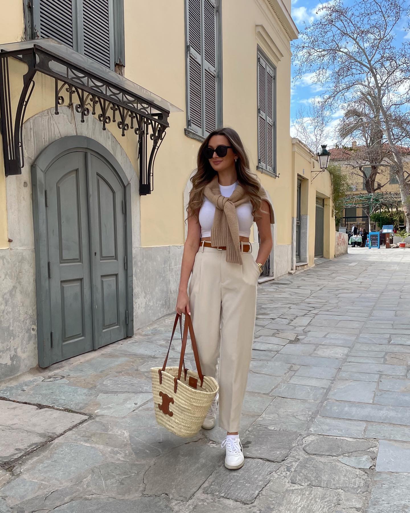 Cream Trousers with White Tank, Draped Knit, and Woven Tote