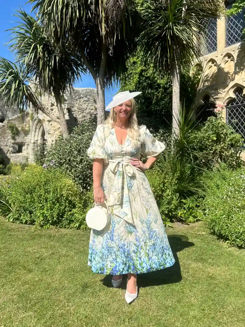 Cream and Blue Floral Midi Dress with Wide-Brim Sun Hat and Round Bag