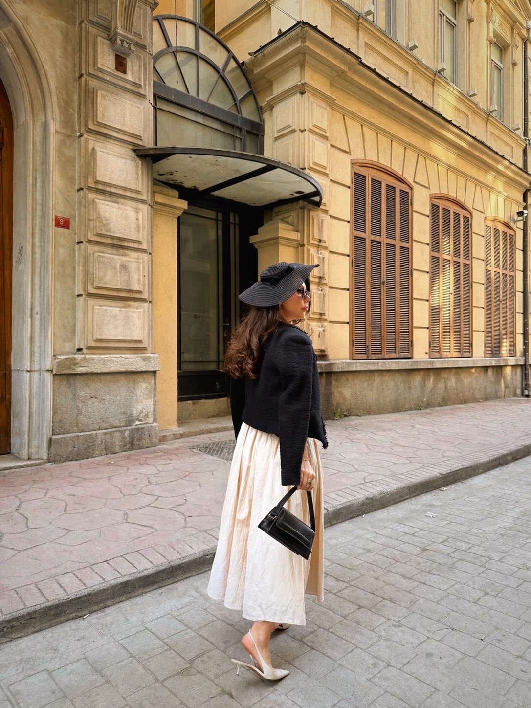 Cropped Black Tweed Jacket with Cream Midi Dress and Wide Brim Hat