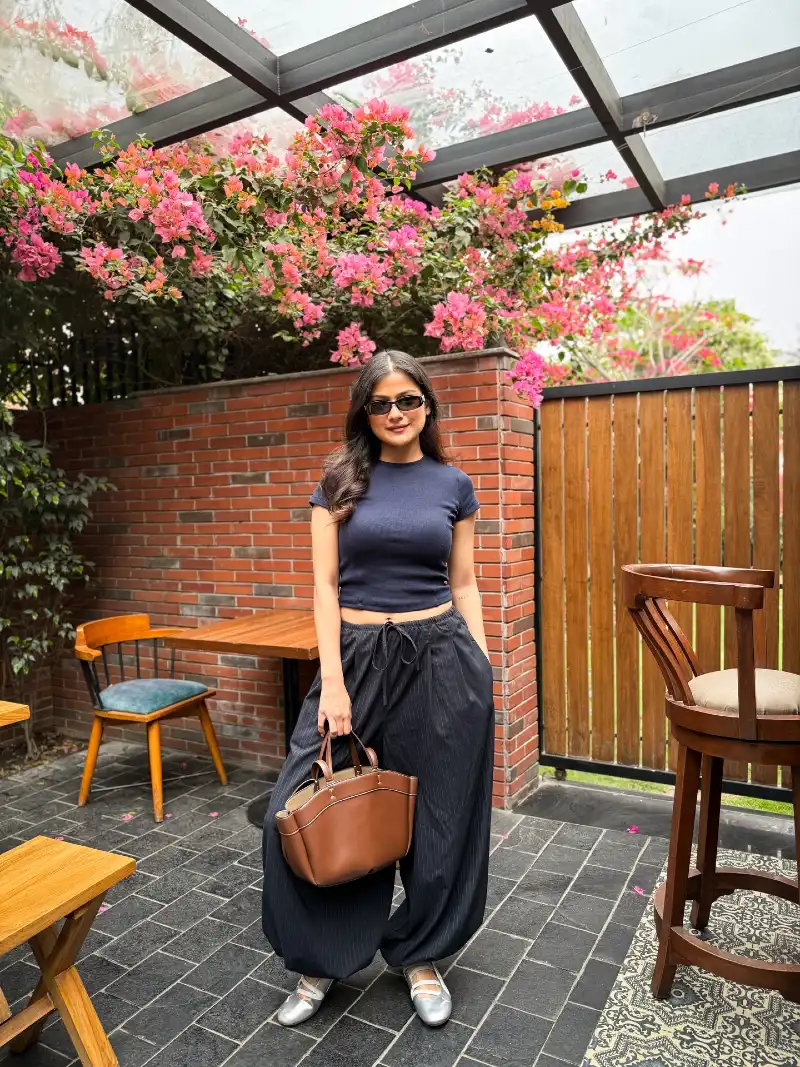 Fitted Navy Crop Top with Voluminous Pinstripe Balloon Pants and Tan Leather Tote