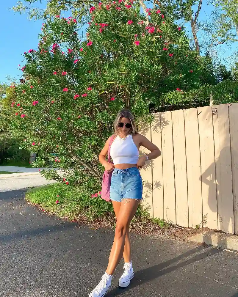 High-Waisted Denim Shorts with White Halter Top, Platform Sneakers, and Pink Tote Bag