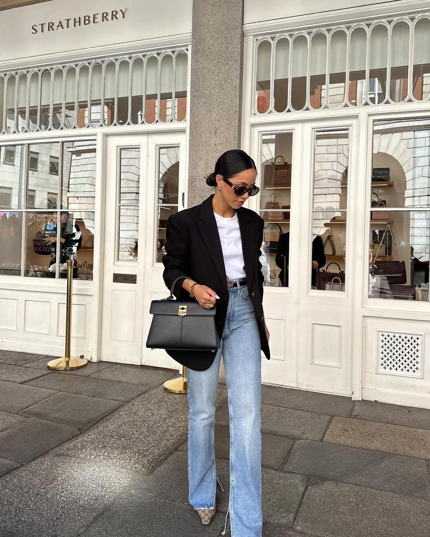 Oversized Black Blazer with Light-Wash Jeans and Structured Handbag