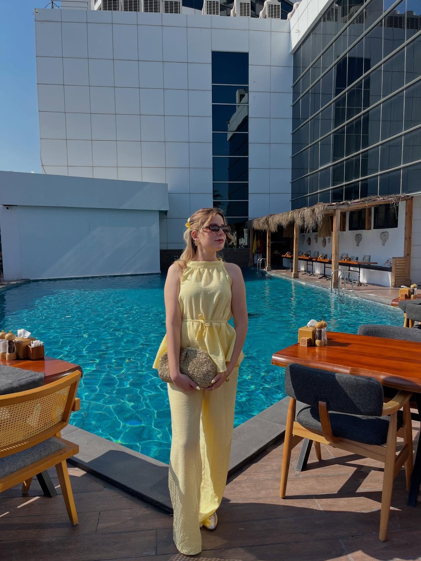 Pale Yellow Halter Set with Woven Clutch and Dark Sunglasses