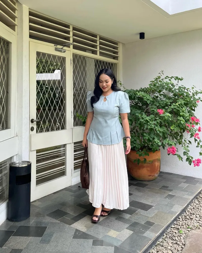 Pastel Blue Peplum Blouse with a Pleated Cream Maxi Skirt and Dark Brown Leather Slides