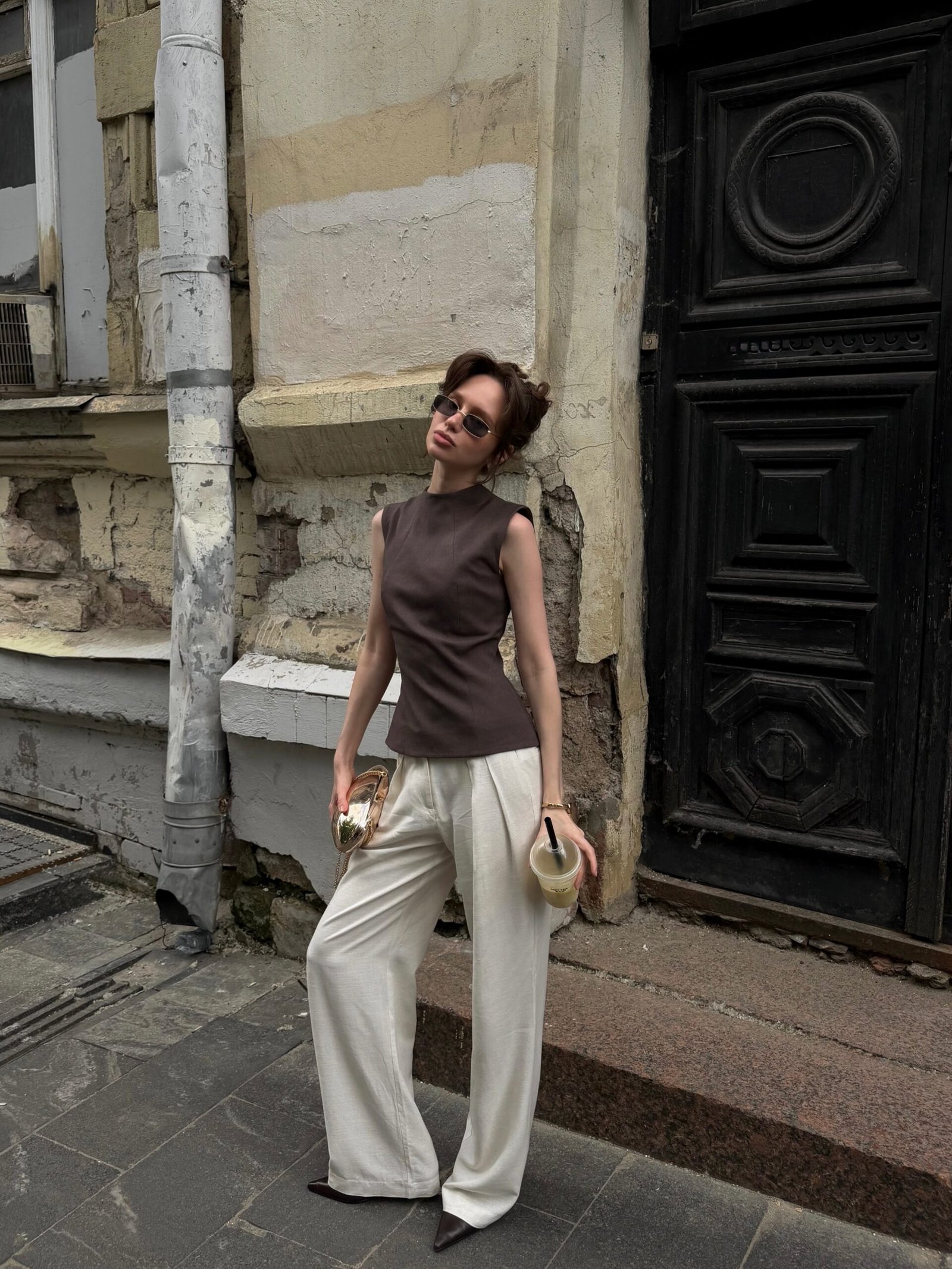 Sleeveless Brown High Neck Top with Cream Trousers and Pointed Shoes