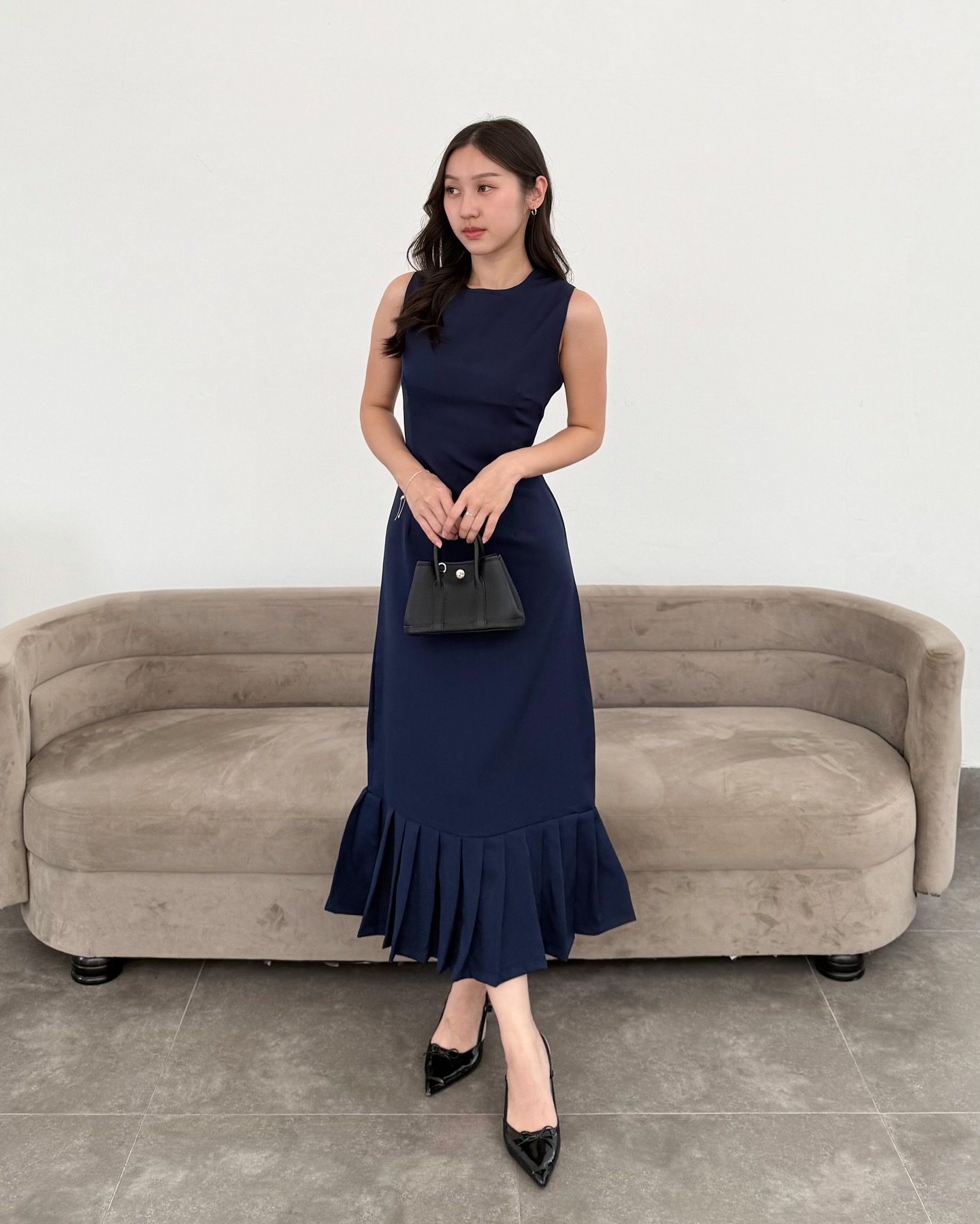 Sleeveless Navy Midi Dress with Pleated Hem and Black Patent Heels
