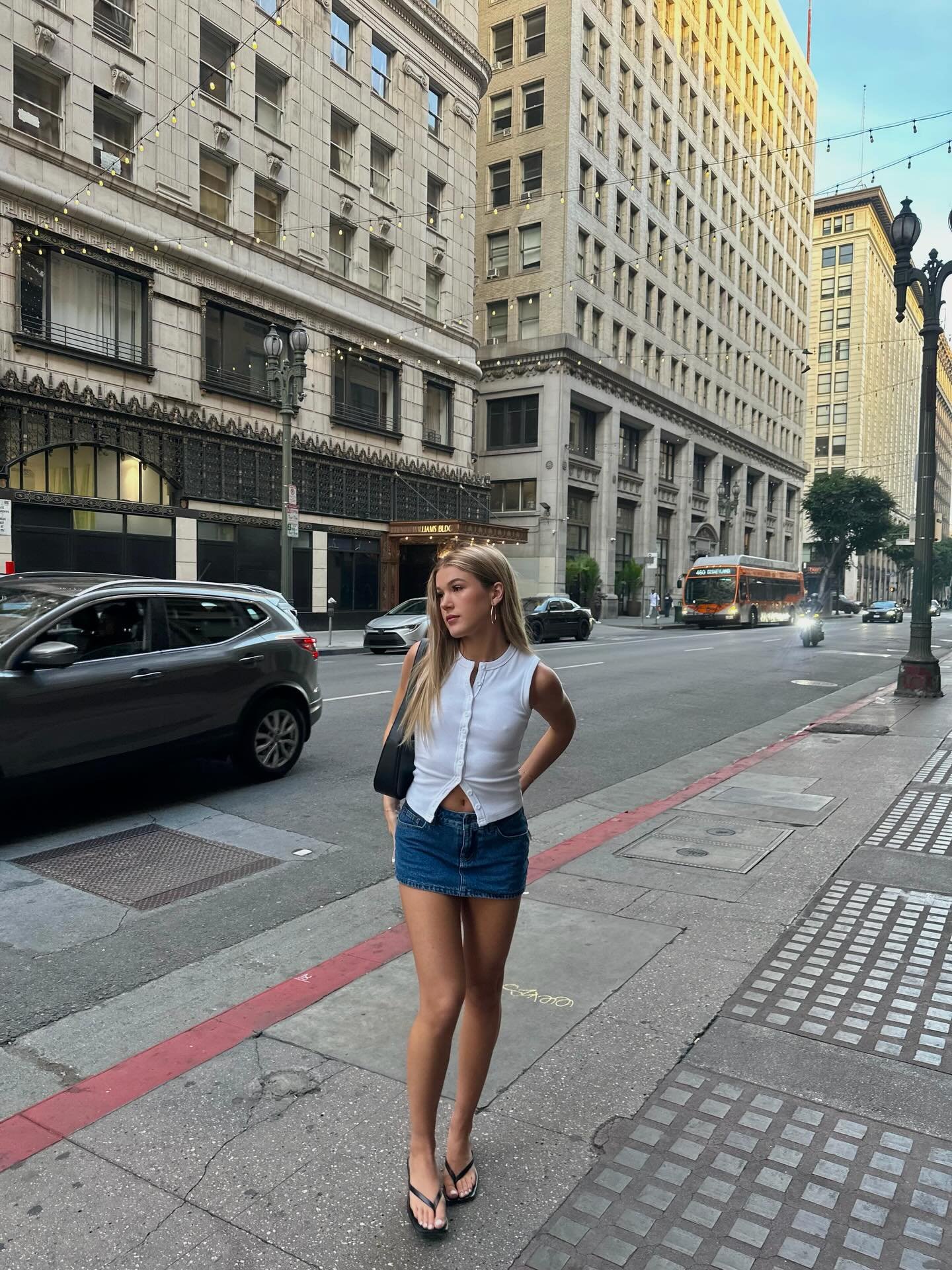 Sleeveless Ribbed White Top with Dark Denim Mini Skirt and Flat Black Sandals Display