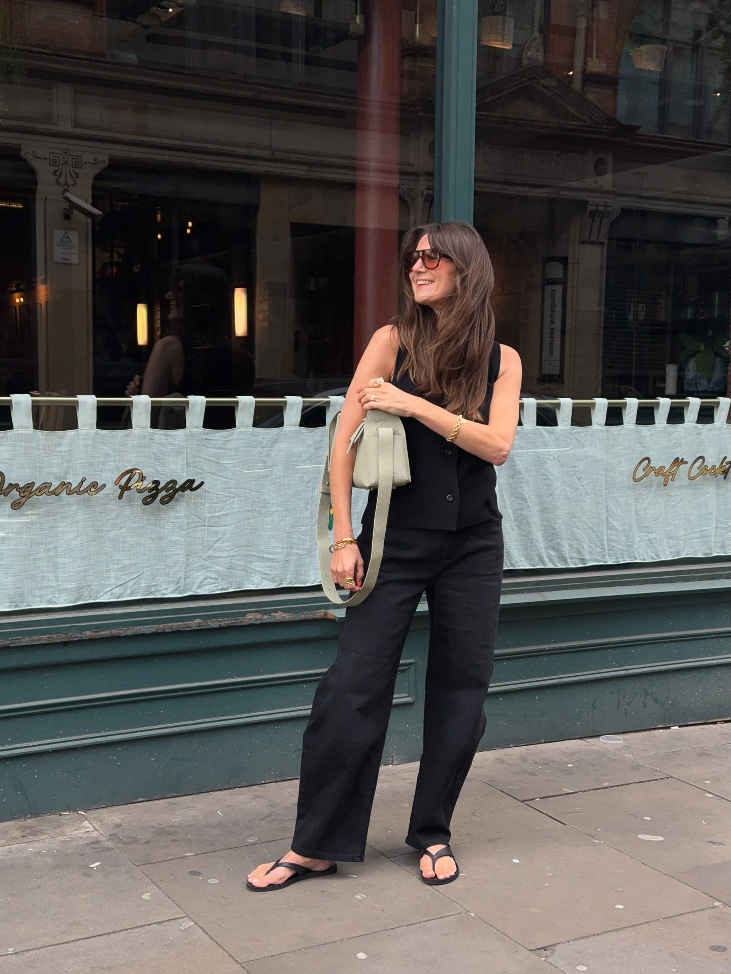 Tailored Black Waistcoat with Relaxed Denim and Sage Canvas Bag