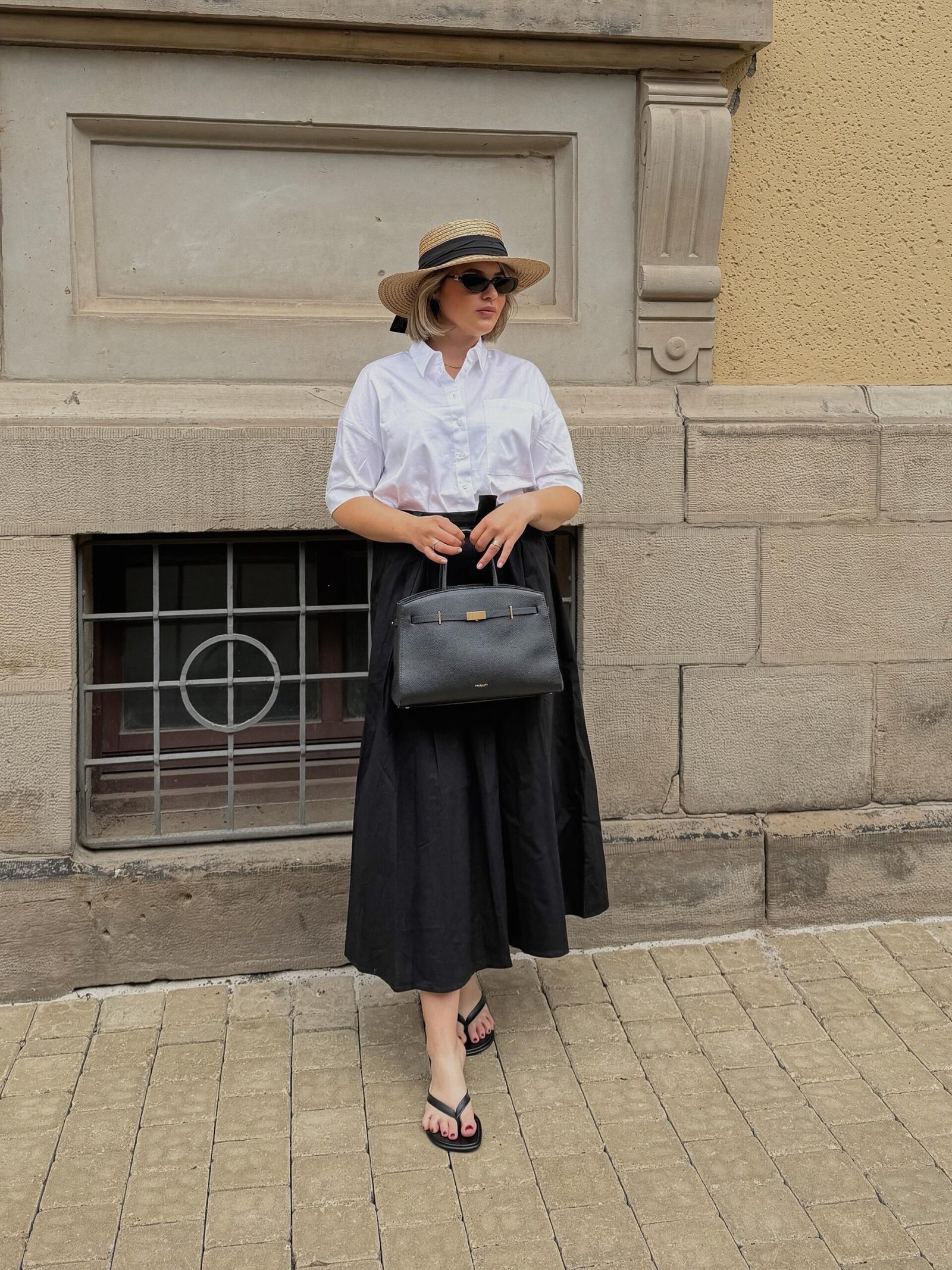 White Cotton Shirt with Voluminous Black Skirt and Straw Boater Hat
