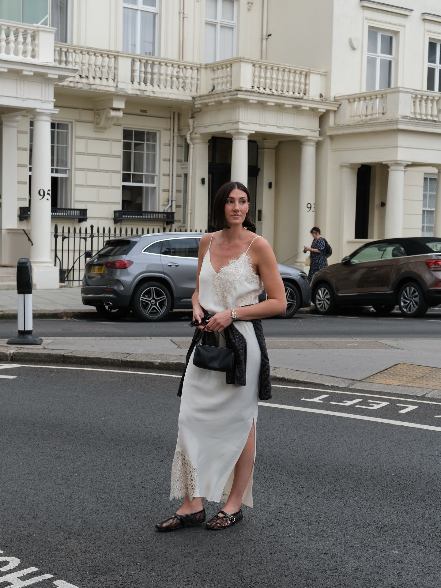 White Lace-Trimmed Slip Dress with Dark Blazer and Mesh Flats