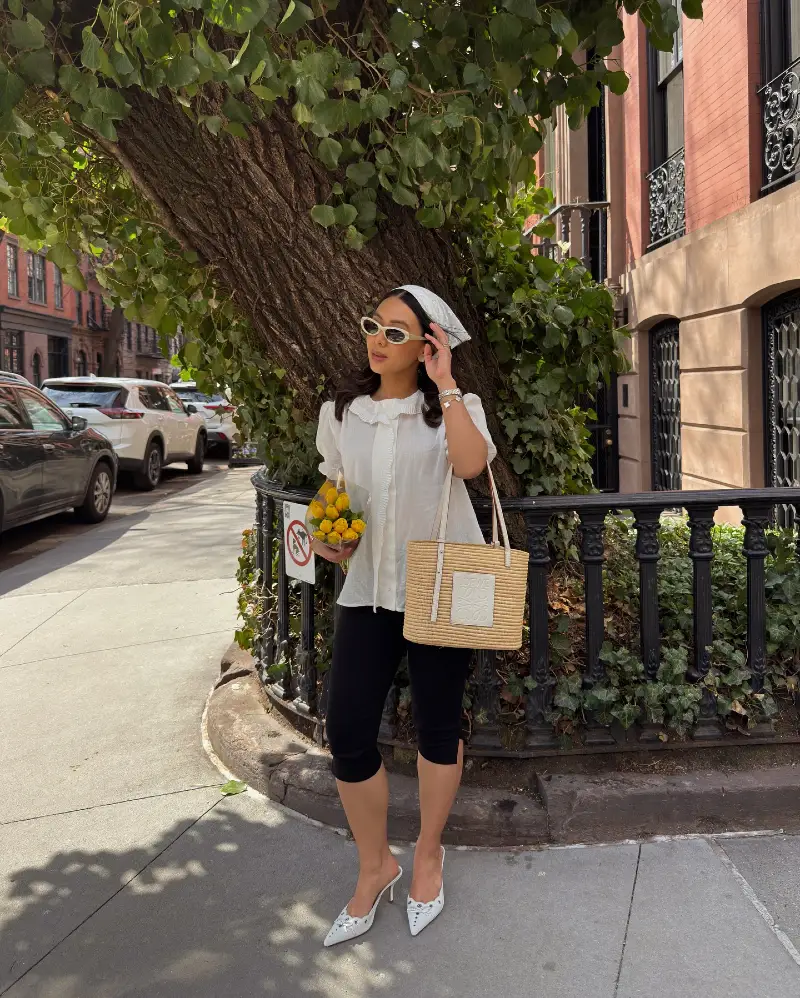 White Ruffled Short-Sleeve Blouse with Black Cropped Leggings and Straw Tote