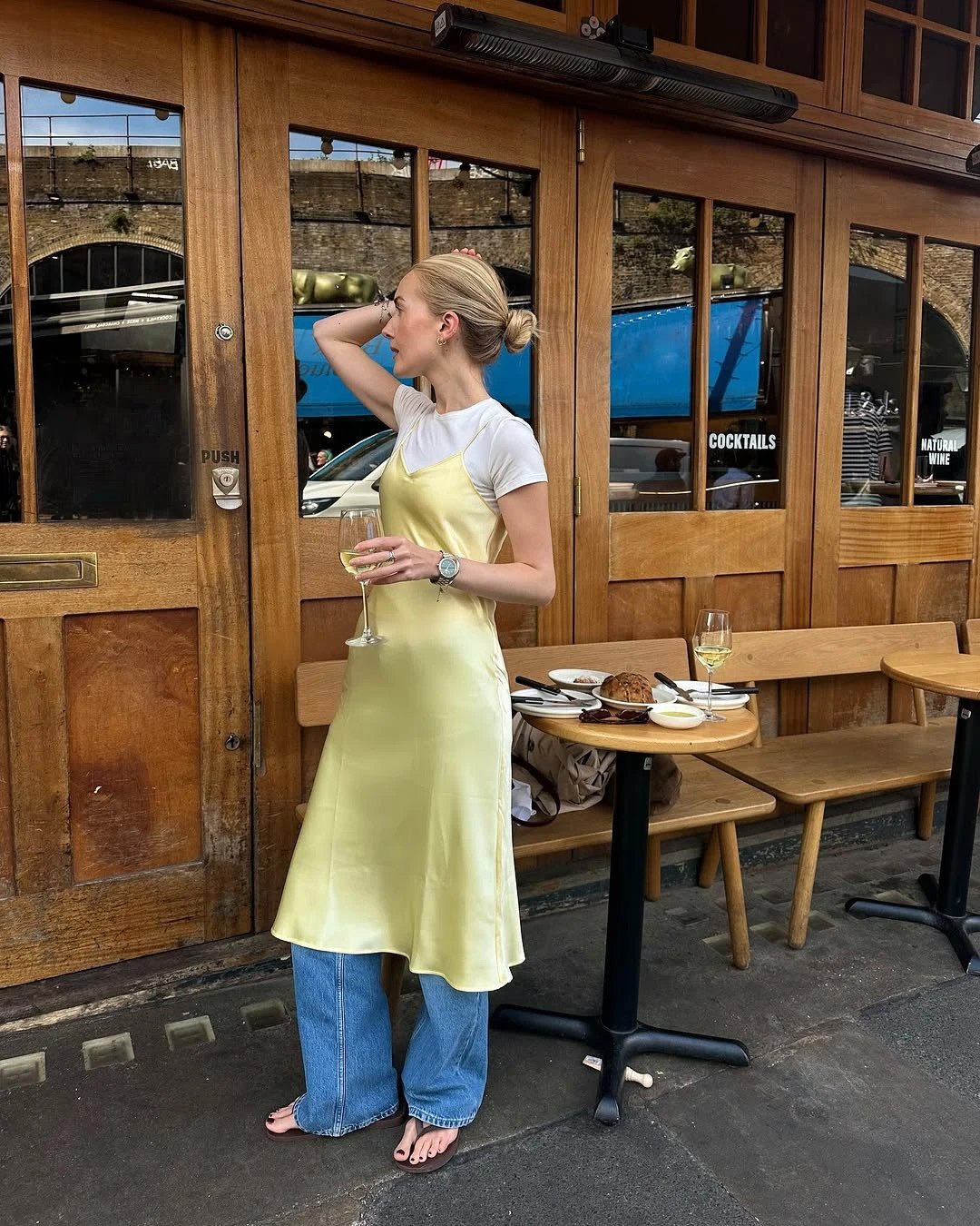 Yellow Slip Dress Layered Over a White T-Shirt and Jeans