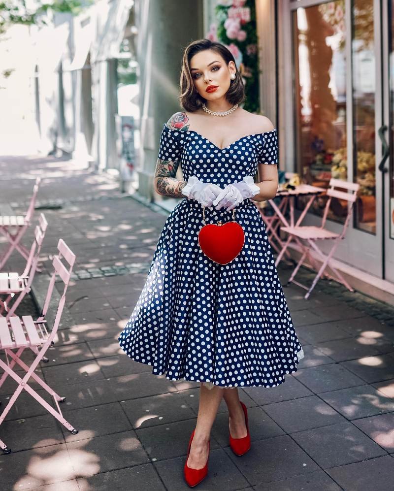 Off-the-Shoulder Navy Dot Swing Dress with Heart Clutch and Red Pumps